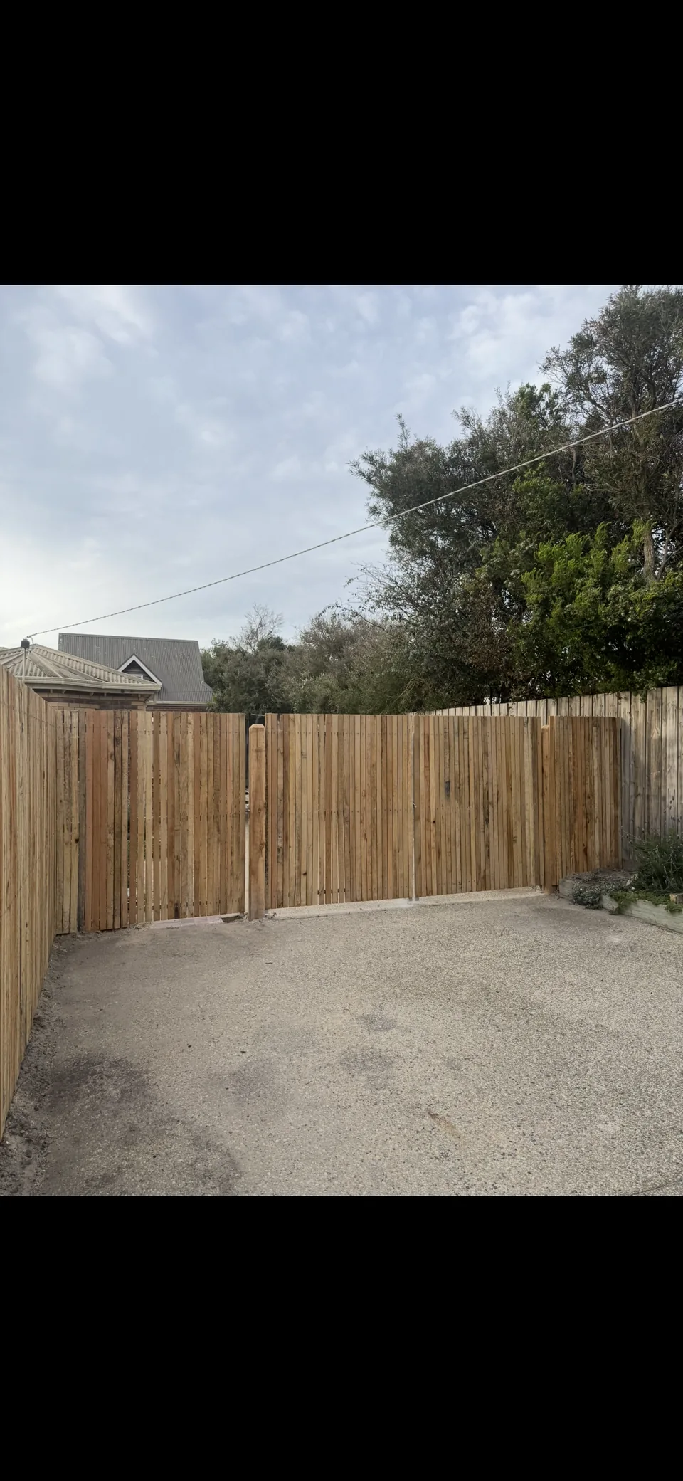 1.8 m high rough-sawn hardwood batten fencing without a plinth board