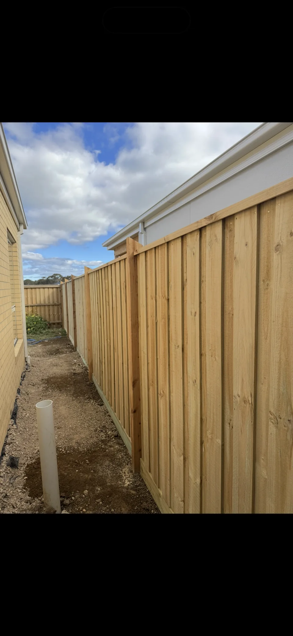 1.95 m paling fence with capping and exposed posts beside a house