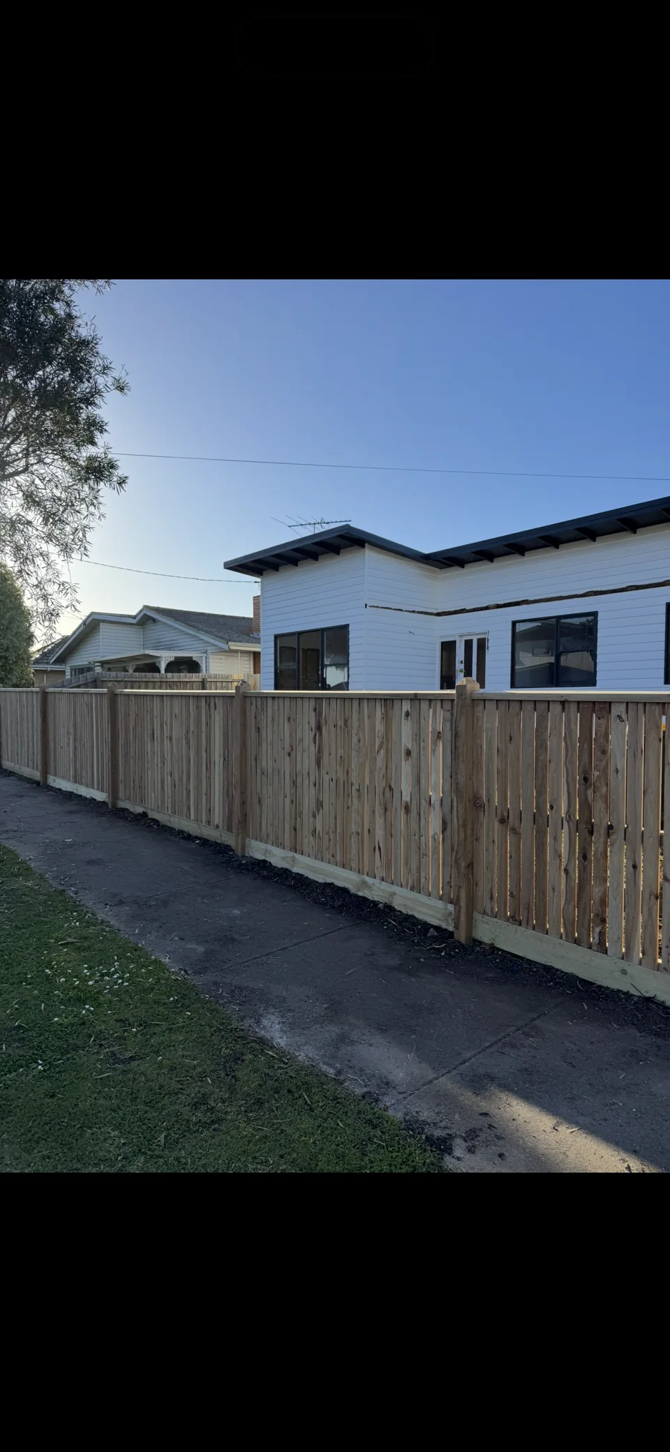 1.2 m cypress picket fence with capping, exposed posts and 10 mm gaps beside a footpath