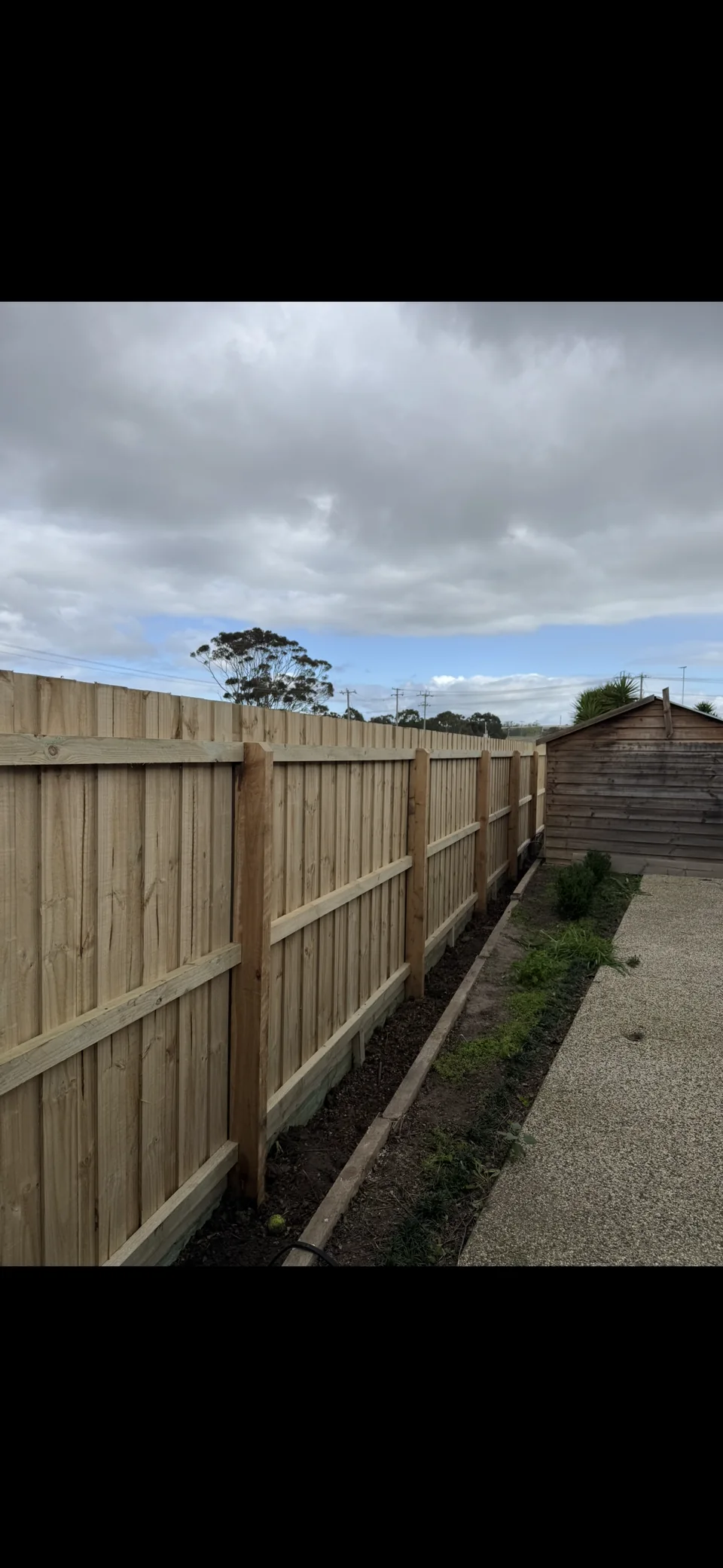 1.95 m paling fence with double plinth boards along a garden boundary
