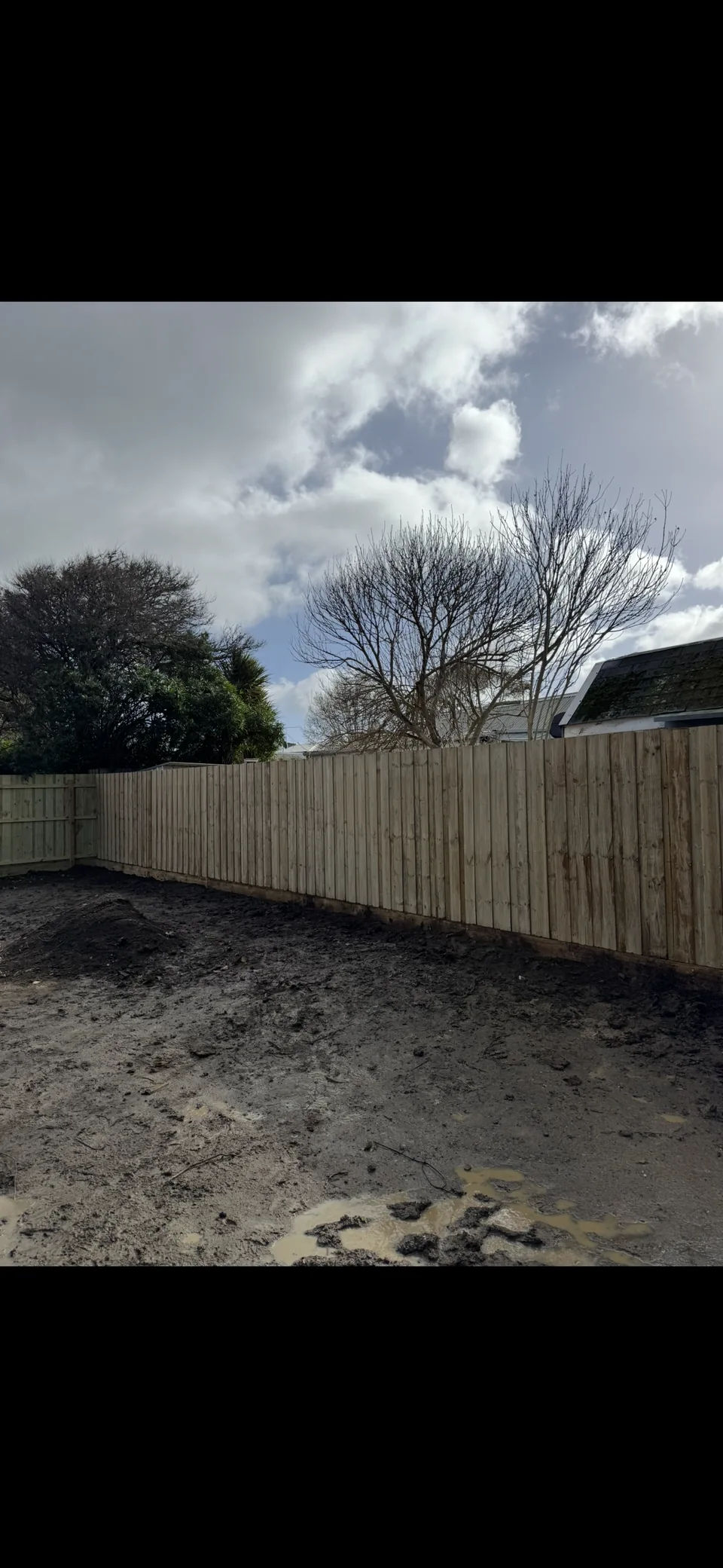 Fence with 1.8 m timber palings and a 200 mm sleeper base around a backyard