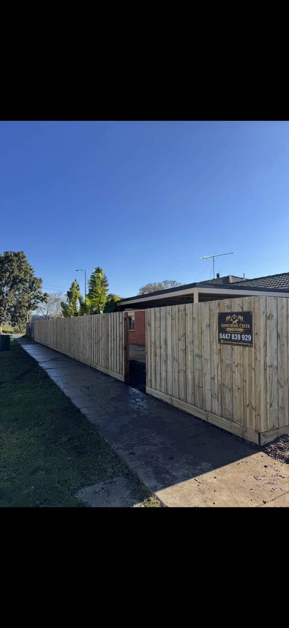1.8 m timber paling fence beside a footpath with an access opening