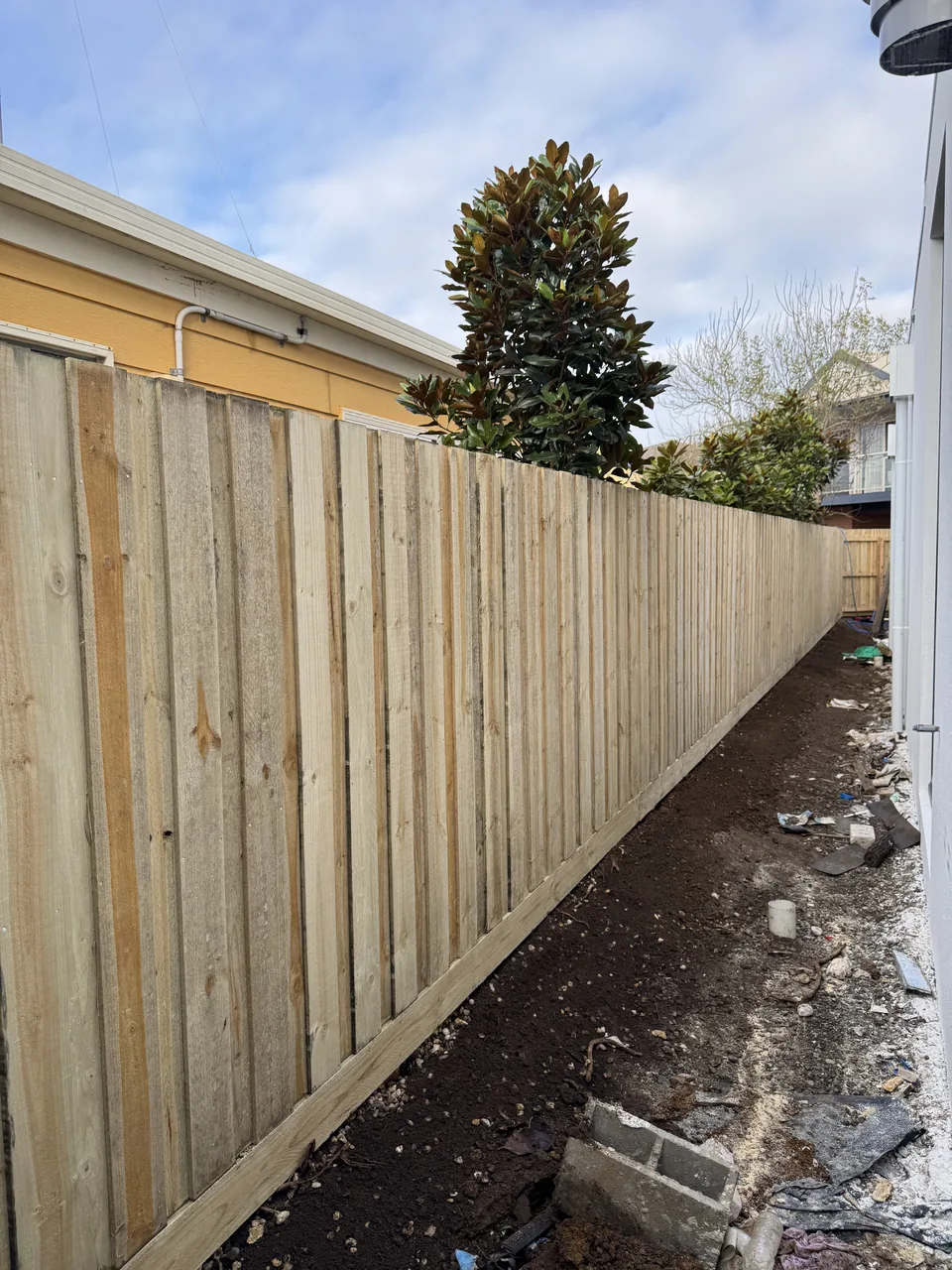 1.8 m timber paling boundary fence alongside a house